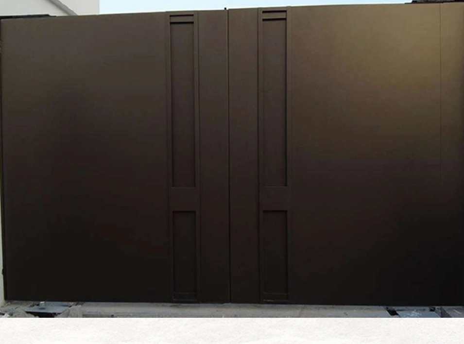 A wide dark gate with solid panels and a coordinated pedestrian-door section.